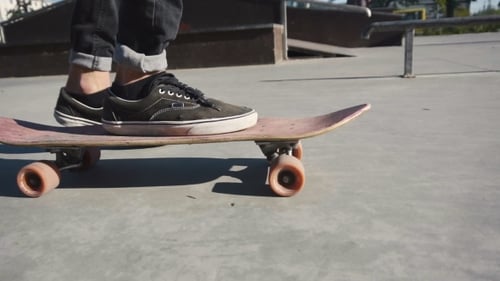 Skateboard Rolling in Urban Skate Park on Sunny Day