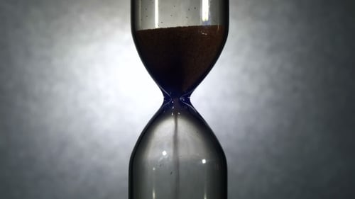 Hourglass On a White Background, The Sand Falls Inside