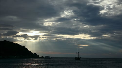 Silhouette of Sailboats on Ocean at Sunset