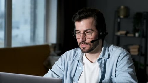 Adult Male Communicating Online With Headset