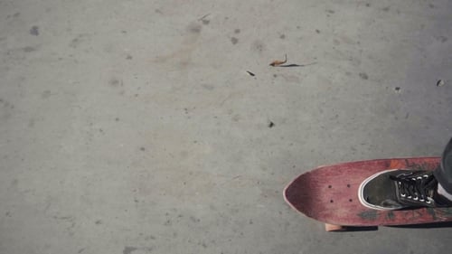 Skateboarder Riding on Concrete in Urban Setting