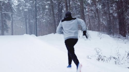 Man Running On Snow Covered Winter Road In Forest 2