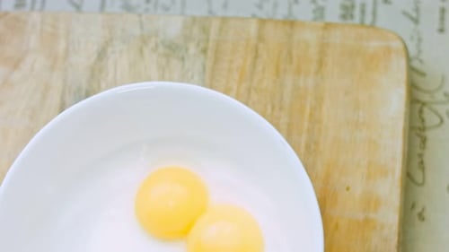 Bright Egg Yolks in a White Bowl