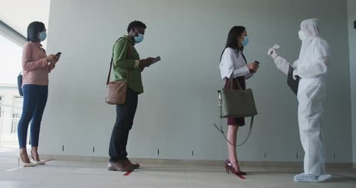 Adults Social Distancing Getting Temperature Checked