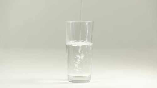 Water Being Poured Into Glass Cup