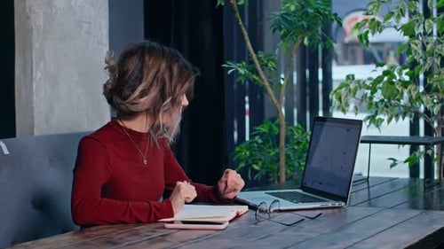 Young Woman Reacts to Finance Data on Computer