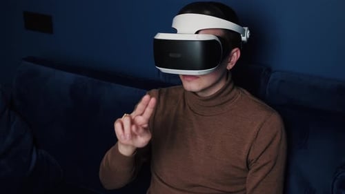 Man Immersed in Virtual Reality on Couch