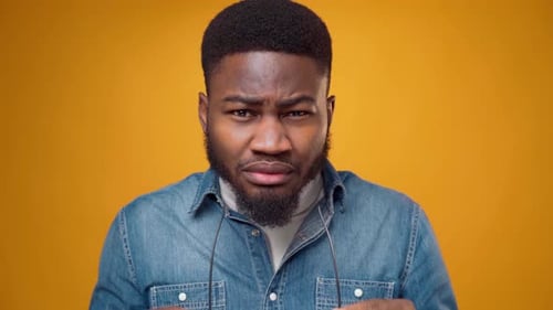 Enthusiastic young adult man posing in glasses