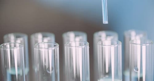 Extreme Close Up of Pipette Dropping Water Into Sample Tube at Laboratory