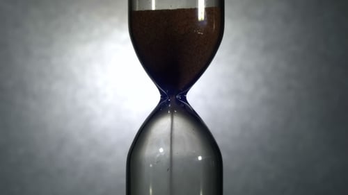 Hourglass On a White Background, The Sand Falls Inside
