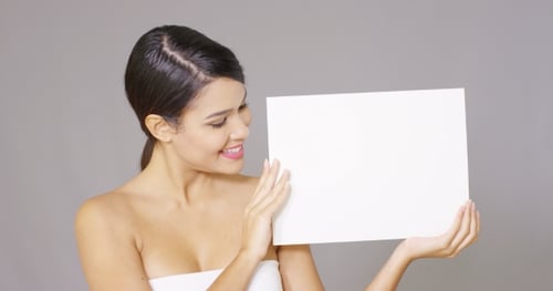 Glamorous Woman Presenting a Blank White Sign
