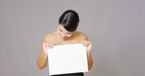 Smiling Woman Holding a Blank White Sign