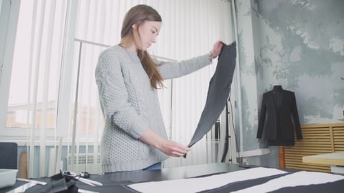 Woman Cutting Fabric in a Bright Design Studio