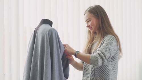 Woman Working on Clothing Design on Mannequin