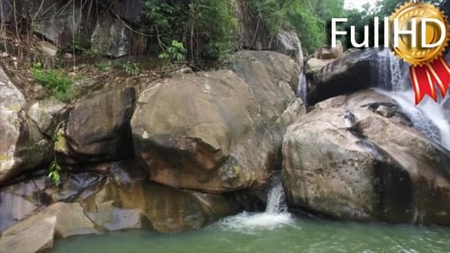 Waterfall in the Mountains Surrounded by Tropical