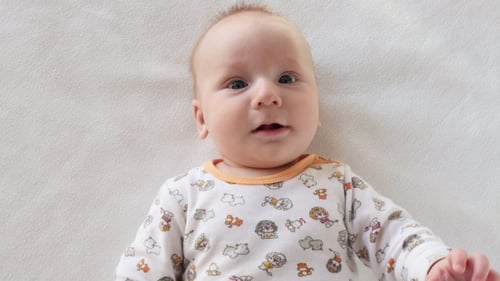 Happy Infant Lying on Blanket Smiling