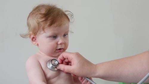 Doctor Examines Infant Chest with Stethoscope Close Up