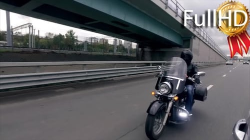 Biker Rides on Classic Motocyle on the Highway