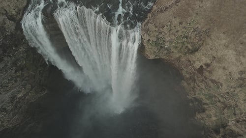 Aerial View of Rushing Waterfall in Natural Landscape