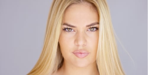 Smiling Woman with Long Blonde Hair in Studio
