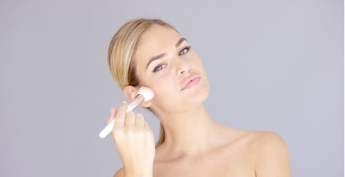 Glamorous Woman Applying Make-Up With Brush