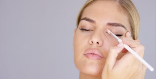 Woman Applying Eye Makeup with Brush, Close Up