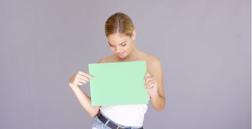Attractive Blond Woman Holding a Blank Green Sign