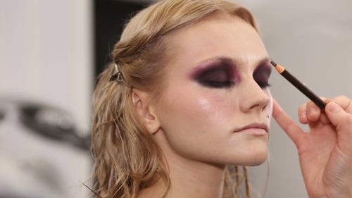 Woman Receiving Eye Makeup from Makeup Artist
