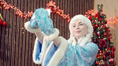 Smiling Woman Taking Selfie with Christmas Decorations