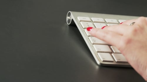 Woman Typing on a Keyboard and Using Mouse