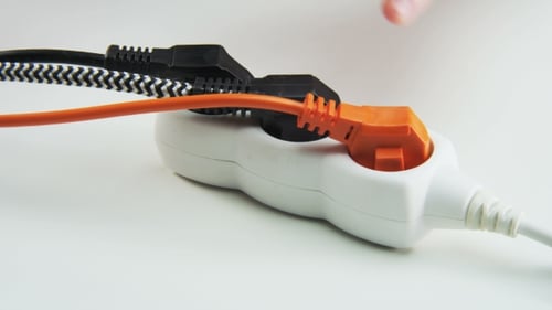 Unplugging Electrical Plugs from White Power Strip
