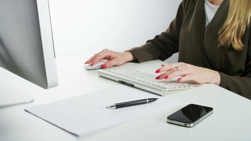 Woman Using Mouse and Typing on a Keyboard