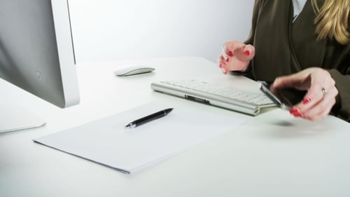 Woman Works at Computer then Uses Phone