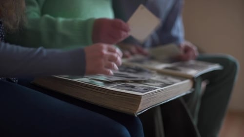 Family Looking Through Vintage Photo Album Together