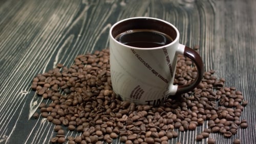 Coffee Mug Surrounded by Roasted Coffee Beans