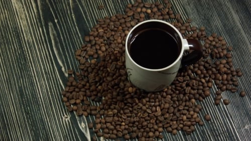 Coffee Cup and Saucer on a Wooden Table, Dark Background with Clipping Path