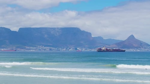 Beautiful Clear Day Looking to Table Mountain and Mother City with Ocean Waves Crashing Over Rocky