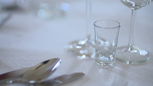 Empty Glassware on White Tablecloth Close Up