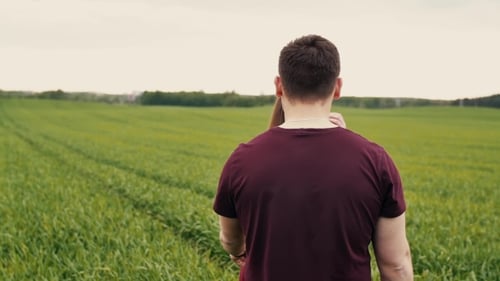 A Man and a Woman Are Joining Hands, Walking in a Field, Hugging and Kissing. , Steadicam Shot.
