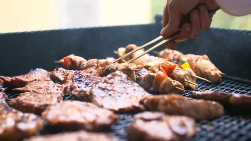 Barbecue Grill with Sizzling Meat and Vegetable Skewers
