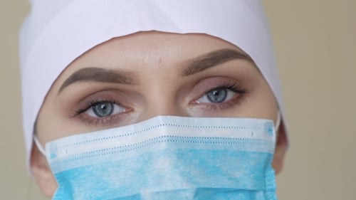 Close Up of Woman Wearing Medical Mask and Cap