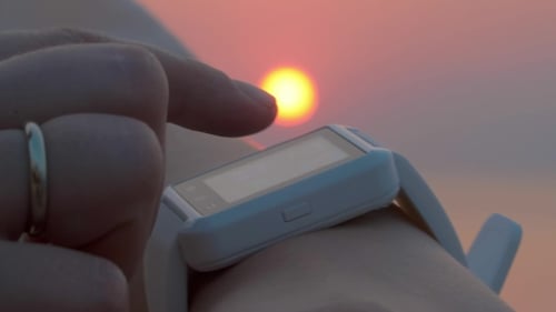 Smart Watch Touchscreen at Warm Sunset on Beach