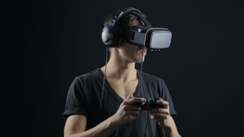 Man Using VR Headset with Game Controller