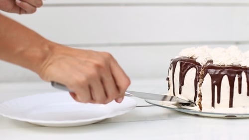 Delicious Cake Being Cut and Served
