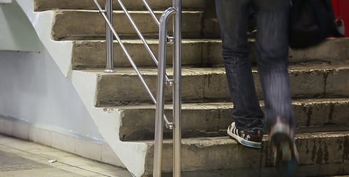 People Walking Up and Down Concrete Stairs