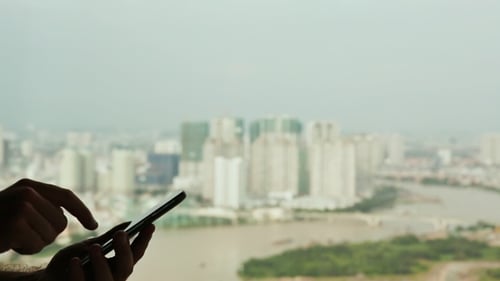 Hands Using Smartphone in Urban Environment