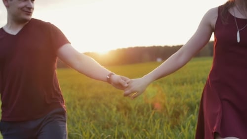 Couple Walk in Beautiful Place at Sunset, Hold Hands. Lovers Hug Tenderly. Woman Wears Glasses