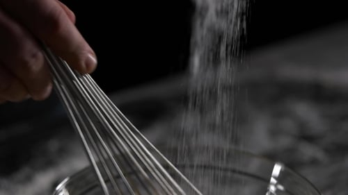 Chef Mixes the Eggs with the Sugar Black Background