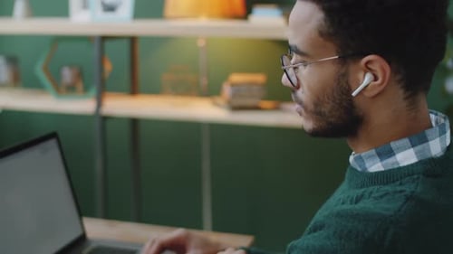 Adult Types on Laptop at Desk Indoors