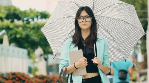Beautiful Asian Young Woman with Tablet in City Street